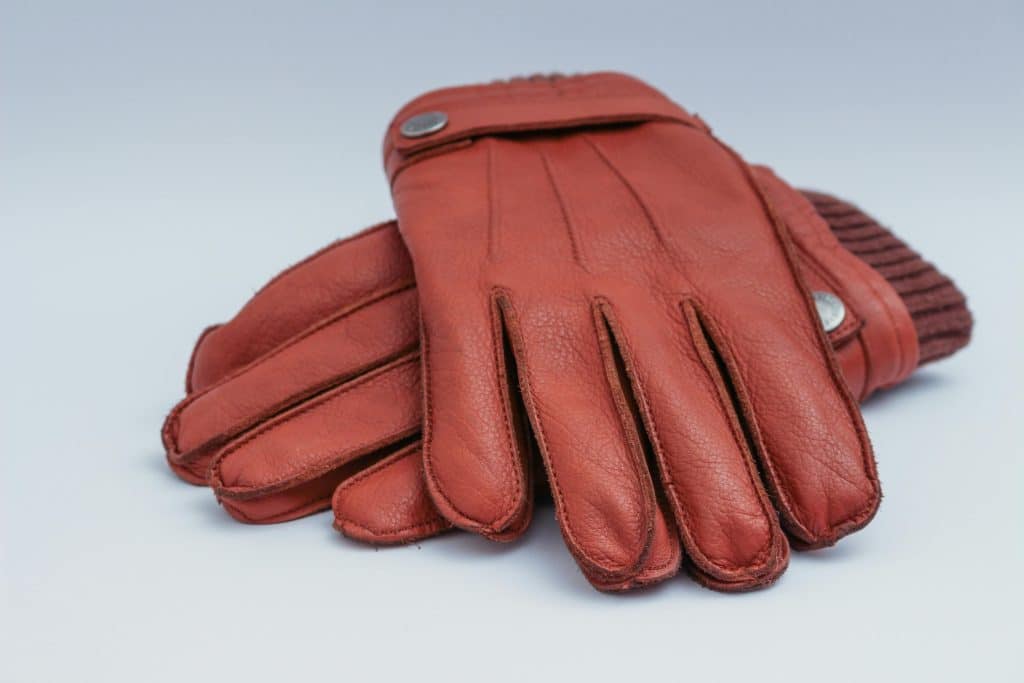 Maroon gloves on white background