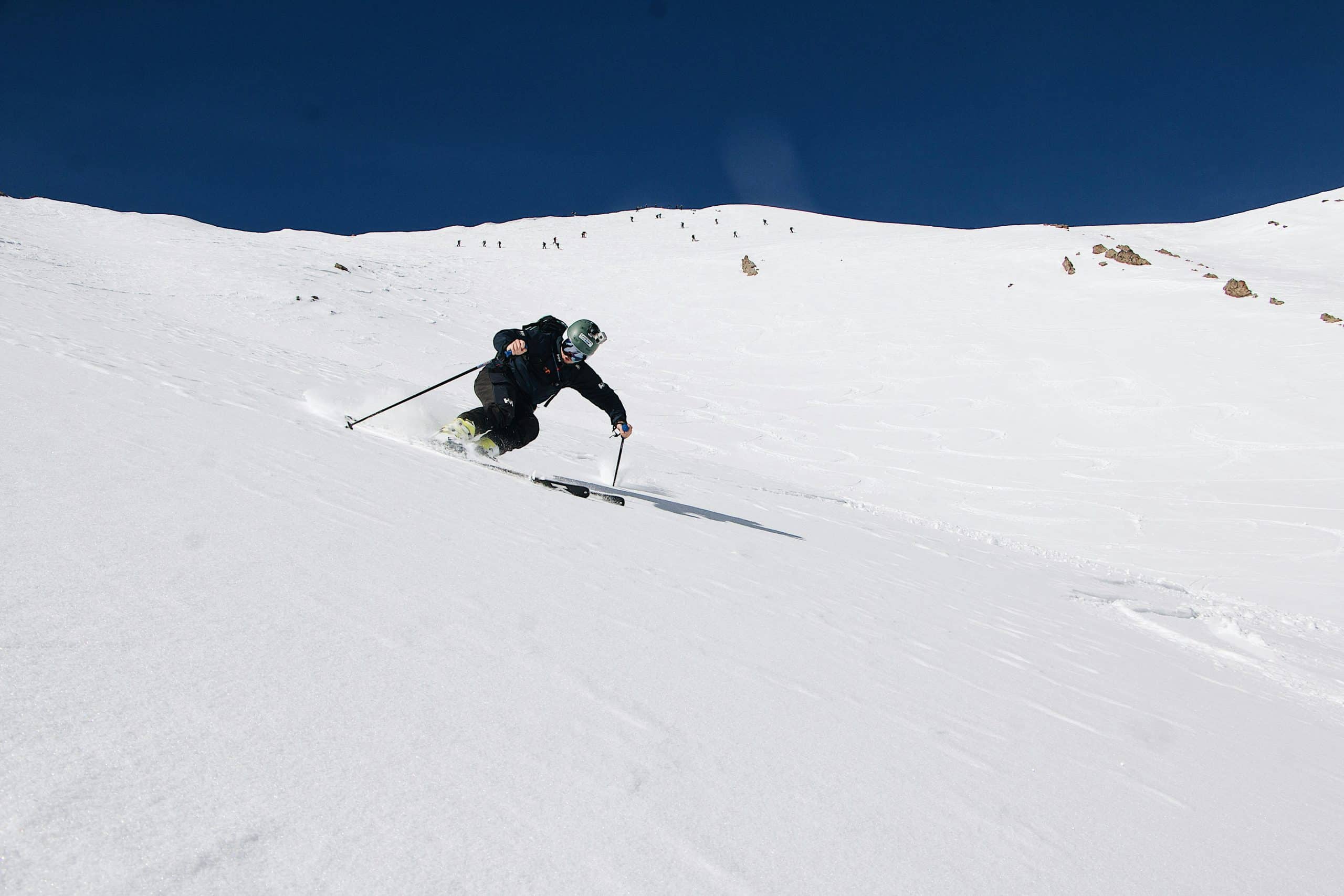 Man sliding down a mountain doing downhill skiing