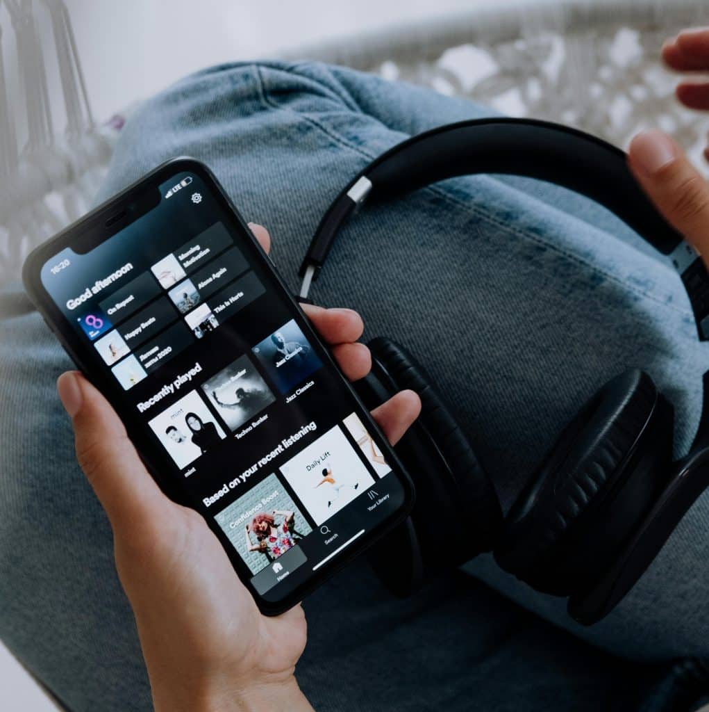 Image of a mobile phone with playslists on the screen